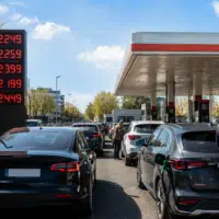 automobilistes dans une station-service face à la hausse des prix du carburant