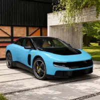 Ferrari électrique bleue devant une villa moderne avec jardin lumineux